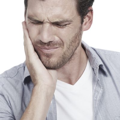 Man holding his jaw in pain from severe toothache, isolated on white