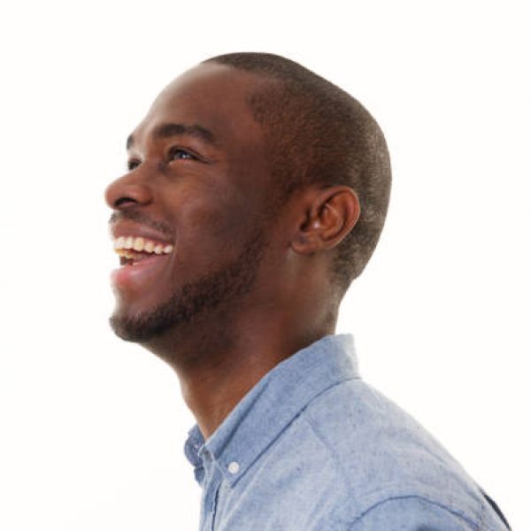 Close up side portrait of laughing african american man looking up